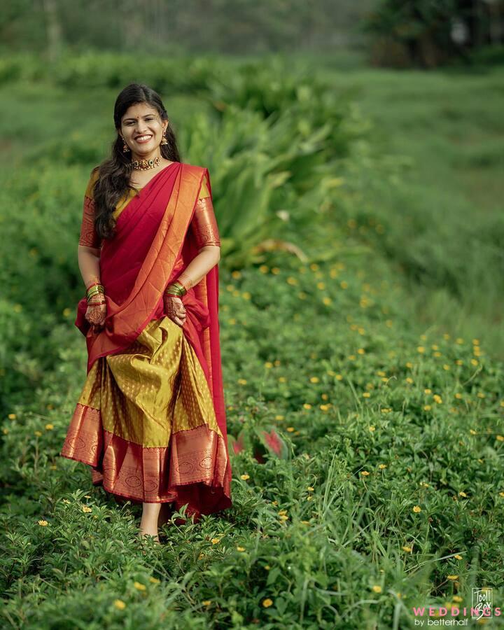 A stunning bride in a vibrant red and yellow South Indian Lehenga