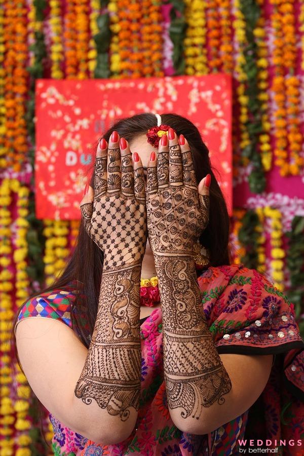 Immerse in vibrant backhand mehndi designs amidst festive celebrations