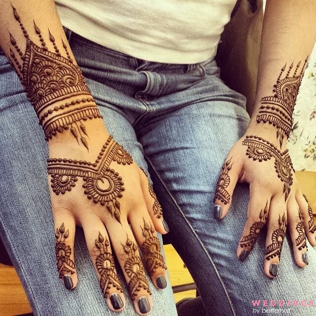 Photo of unique minimalist mehndi design on back hand