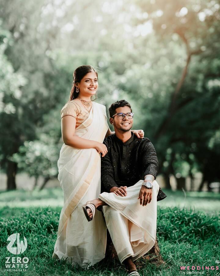 An Indian couple in traditional attire posing amidst the natural beauty of a park