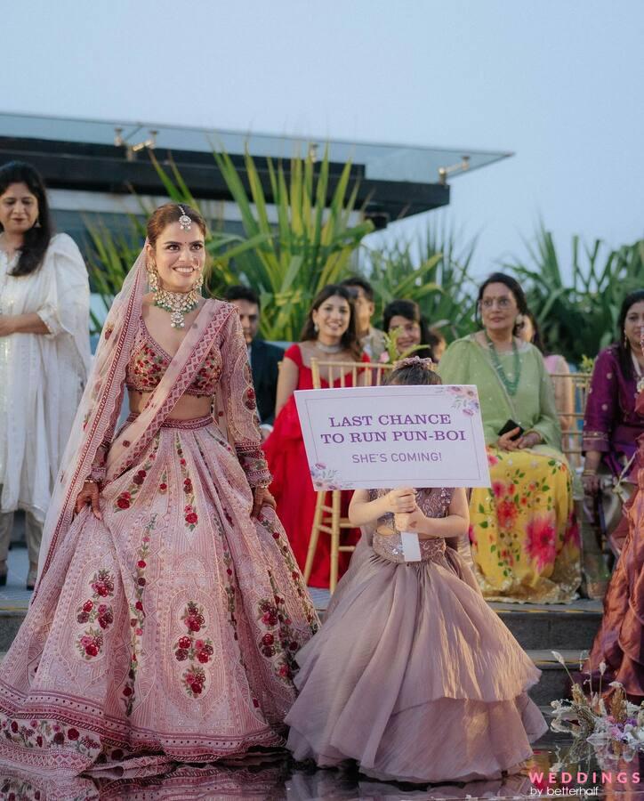 A group of Indian brides walking down the aisle with adorable flower girls. Get inspired for your wedding celebration!