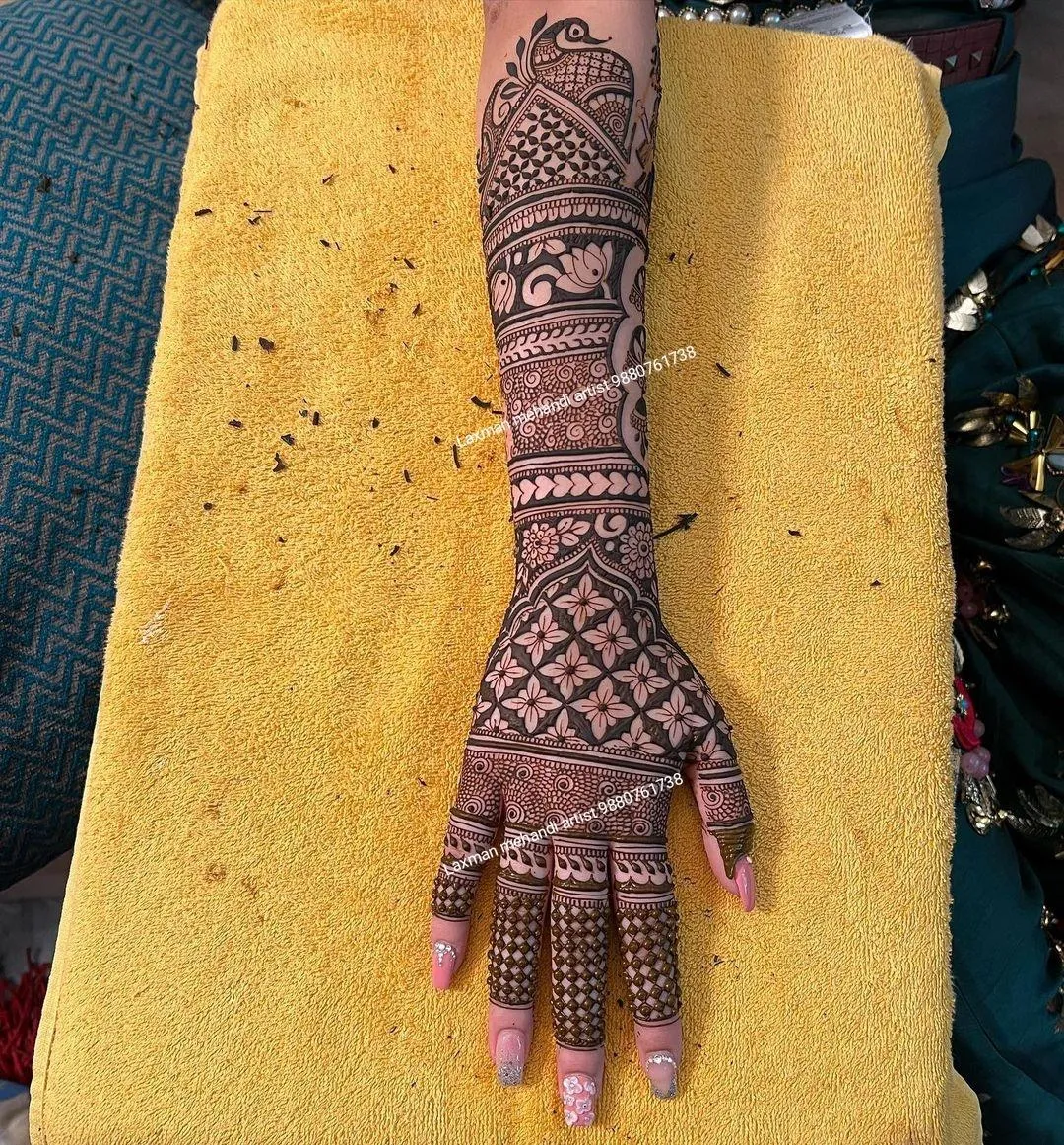 Photo of detailed mehndi design on full back hand to finger