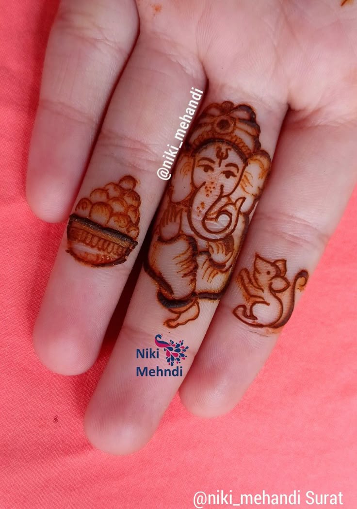 Ganesh Ji and Mushak Mehendi Design on Kids Finger Photo of Ganesh Ji and Mushak Mehendi Design on Kids Finger