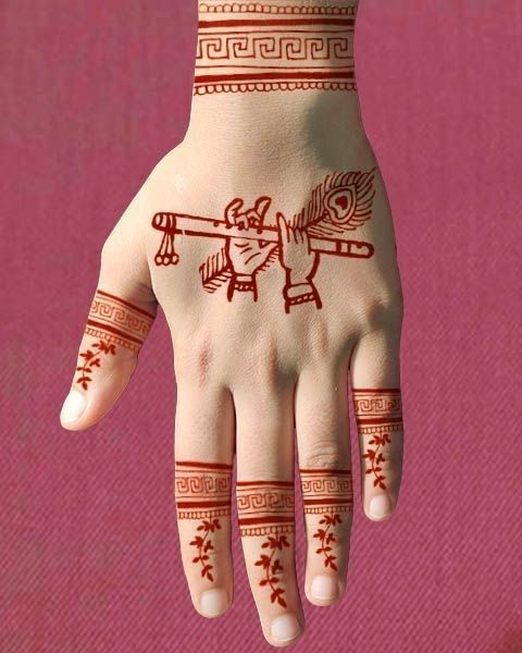 Traditional Janmashtami Mehendi with Flute and Feather Motifs for kids backhand Photo of Traditional Janmashtami Mehendi with Flute and Feather Motifs for kids backhand