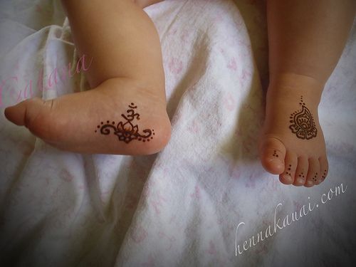Traditional om symbol mehndi on baby's feet Photo of Traditional om symbol mehndi on baby's feet