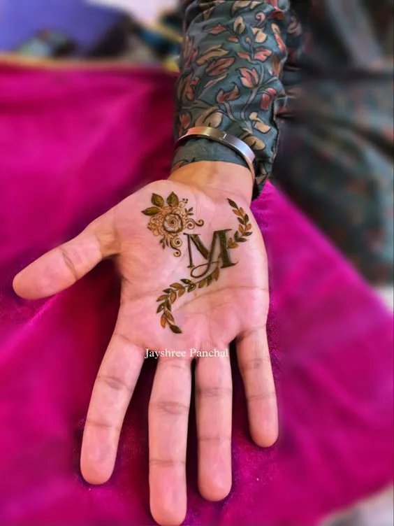 Photo of Simple Initial mehndi design for groom front hand