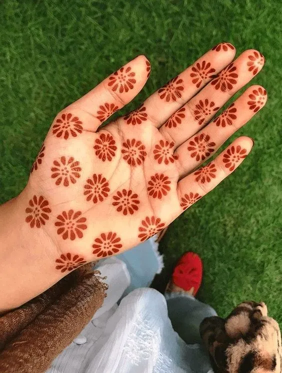 Small floral prints mehndi design on front hand Photo of Small Floral Mehndi Prints
